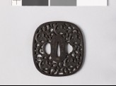 Tsuba with heraldic device and karakusa, or scrolling plant pattern