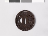 Tsuba in the form of a basket containing iris leaves and chrysanthemums (EAX.10401)
