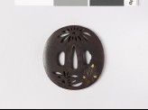 Lenticular tsuba with chrysanthemum flowers and leaves