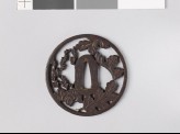 Round tsuba with chrysanthemum leaves and mon made from kiri, or paulownia leaves