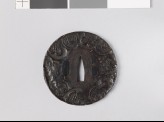 Round tsuba depicting old Chinese coins among mokkō shapes and scrolls (EAX.10749)