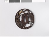 Tsuba depicting a crane standing among reeds, rocks, and water