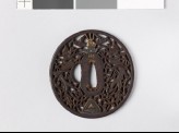 Tsuba with dragons and karakusa, or scrolling plant pattern