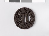 Tsuba with animals amid karakusa, or scrolling plant pattern