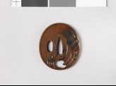 Tsuba depicting a monkey hiding from an eagle (EAX.11005)