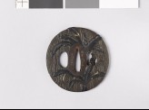 Lenticular tsuba with wood grain decoration and banana trees (EAX.11126)