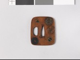 Aori-shaped tsuba depicting charms, coins, and three of the Seven Treasures