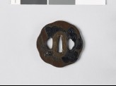 Tsuba with butterfly and mon made from kiri, or paulownia leaves