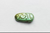 Oval cabochon amulet with inscription in cursive script and branch decoration