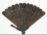 Tortoiseshell fan with figures in a landscape