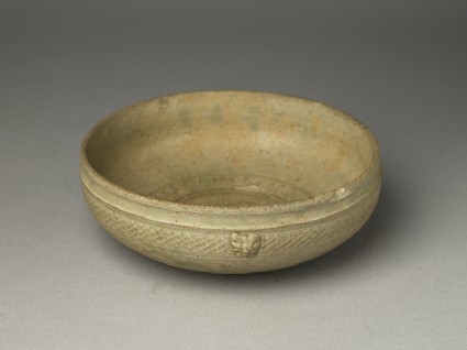 Greenware bowl with animal masksoblique