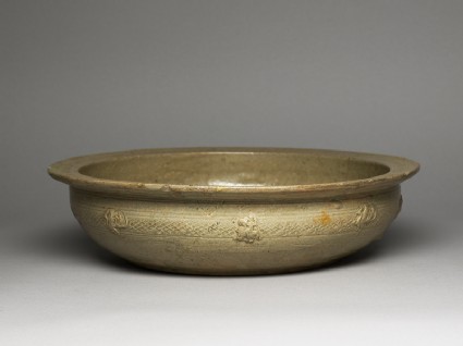 Greenware basin with fish, phoenix, and riding figuresoblique