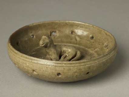 Greenware burial figure of dog in a penoblique