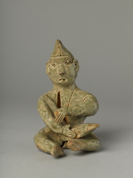 Greenware burial figure of man playing a harpfront