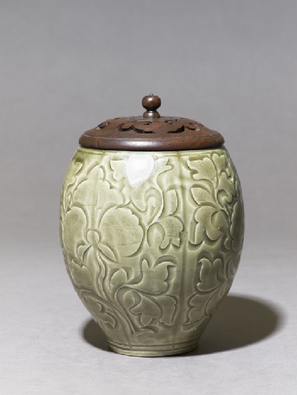 Greenware jar with floral decoration and modern lidside