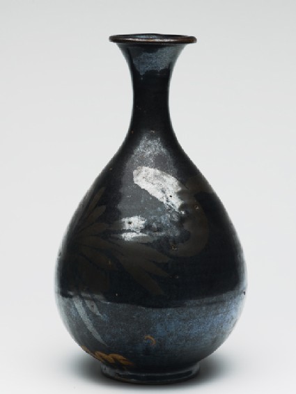 Black ware bottle with floral decorationside
