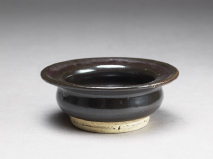 Black ware bowl with iron glazeoblique