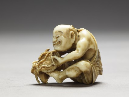 Netsuke in the form of a man making a matside