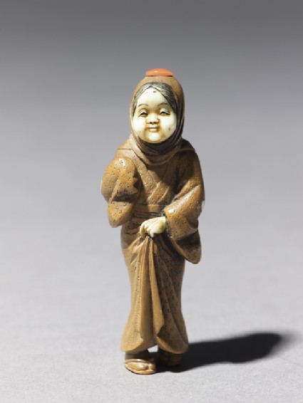 Netsuke in the form of a figure wearing a mask of Okame, a merry Shinto goddessside