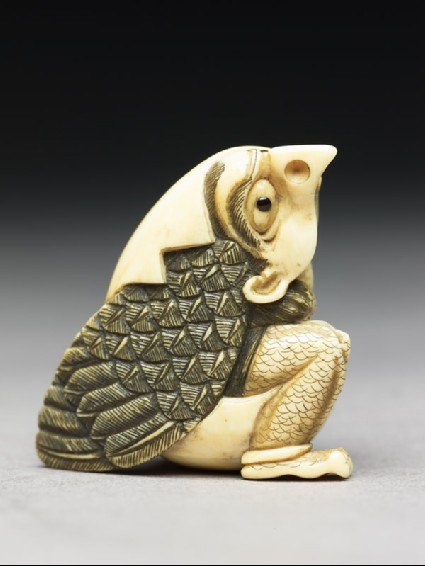 Netsuke in the form of a tengu mountain demon emerging from an eggside