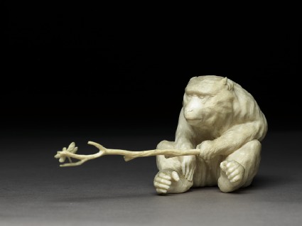 Okimono, or ornament, in the form of a monkey holding a branchside