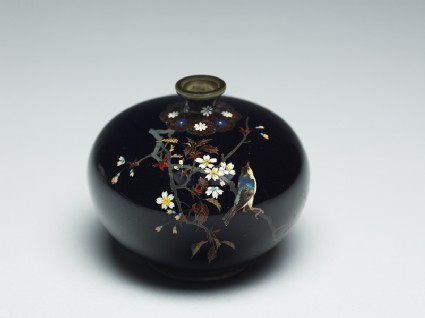 Bottle with a bird on a flowering branchoblique