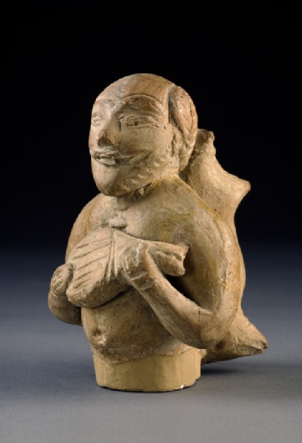 Figure of a musician carrying a water-skinoblique