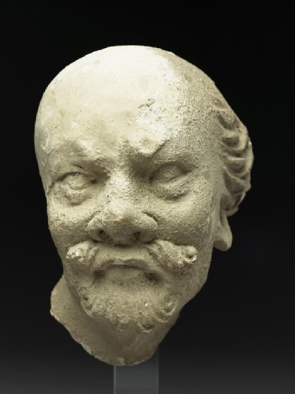 Stucco head of a manfront