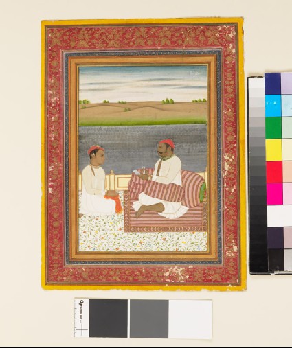 Man seated on a terrace with an attendant or pupilfront