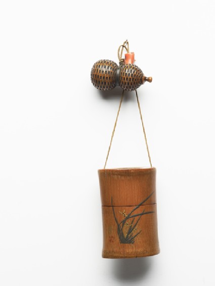 Tonkotsu, or tobacco container, attached to a gourd-shaped netsuke and an ojimefront