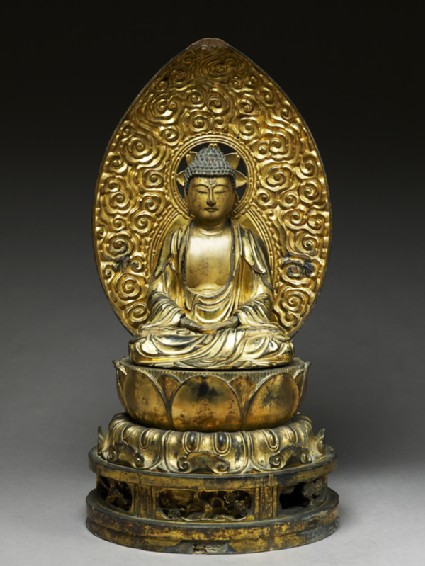 Figure of the Buddha with a mandorla, or halo, seated on a lotus pedestalfront