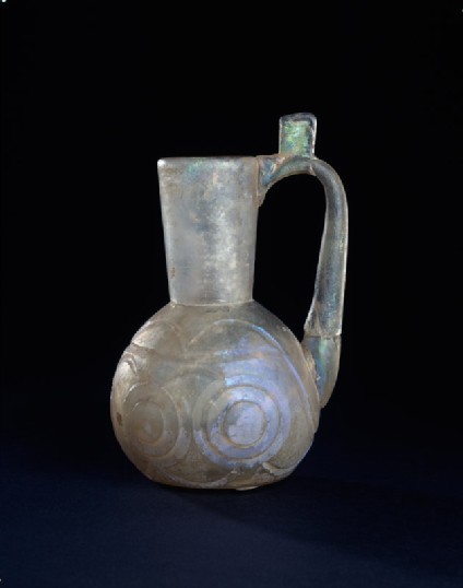 Glass jug with raised disc decorationside