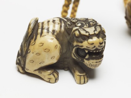 Netsuke in the form of a shishi, or lion dogoblique