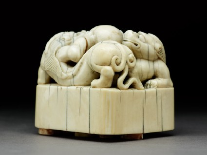 Ivory seal surmounted by two shishi, or lion dogsside