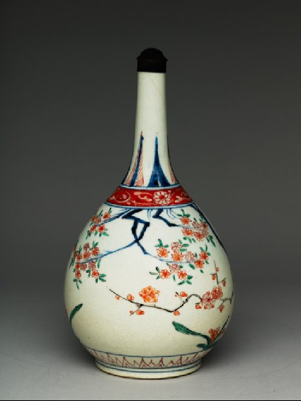 Bottle with flowering prunus and peach treesside