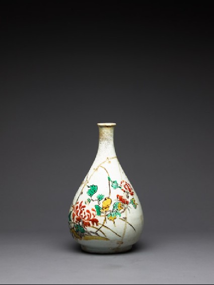 Bottle with bird amid peonies and grassesside
