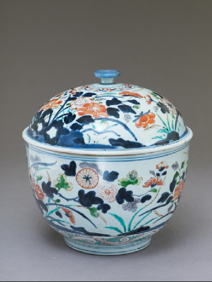 Tureen with peony and chrysanthemum growing from rocksoblique