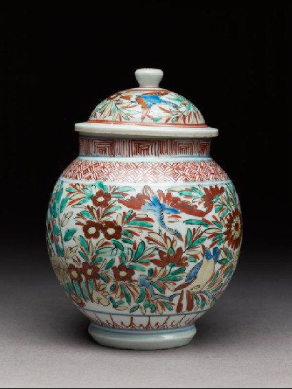 Jar with birds and butterflies among flowersside