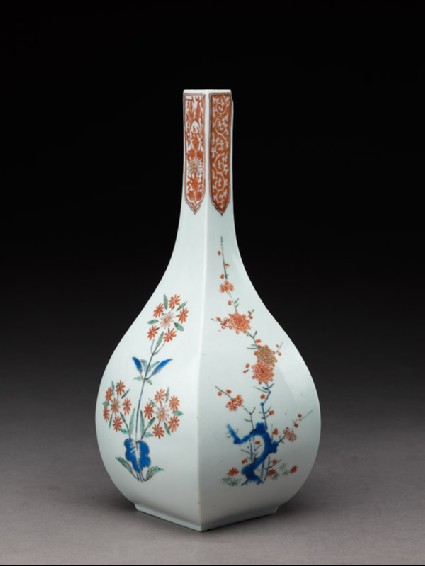 Squared bottle with prunus and formal daisy plantsside