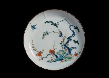 Lobed plate with pine, prunus, and bamboo growing from rocksfront