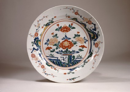 Dish with peonies on a terracetop