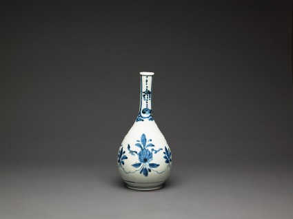 Bottle with formal lotus flower and leaf spraysside