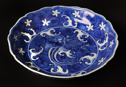 Blue-and-white dish with animals amid wavesfront