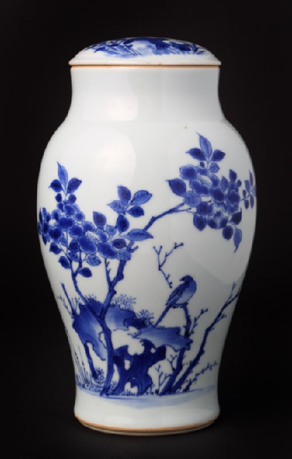 Blue-and-white jar and lid with birds, rocks, and plantsfront