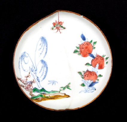 Dish in the form of a peach with willow, butterfly, and peachesfront