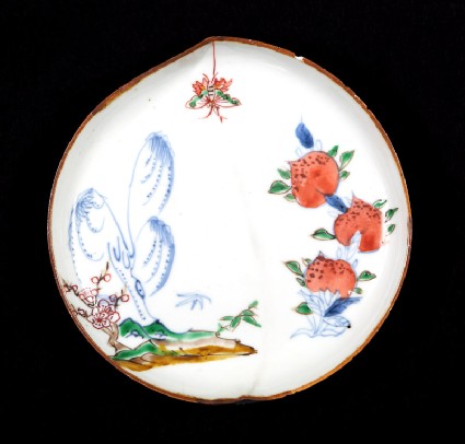 Dish in the form of a peach with willow, butterfly, and peachesfront