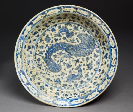 Dish with peacock and deer amid floral scrollstop
