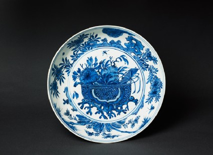 Blue-and-white dish with basket of flowerstop