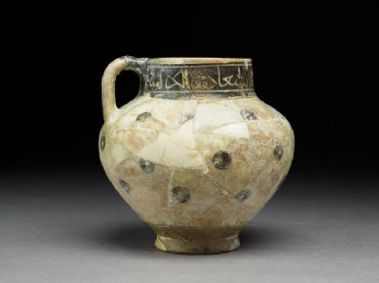 Jug with circles and inscriptionside