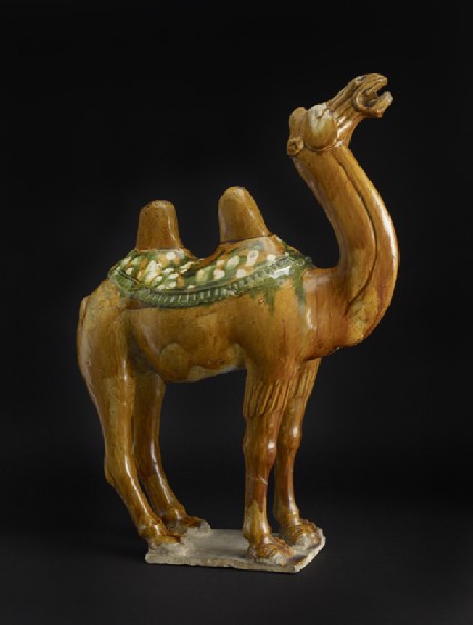 Earthenware figure of a camel with a saddle clothoblique